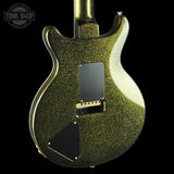 Glossy green electric guitar with a black pickguard on a black background, featuring 'Tone Shop' branding.