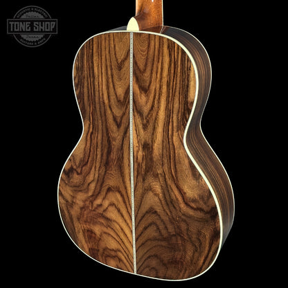 Wooden acoustic guitar body with a visible brand logo in the corner.