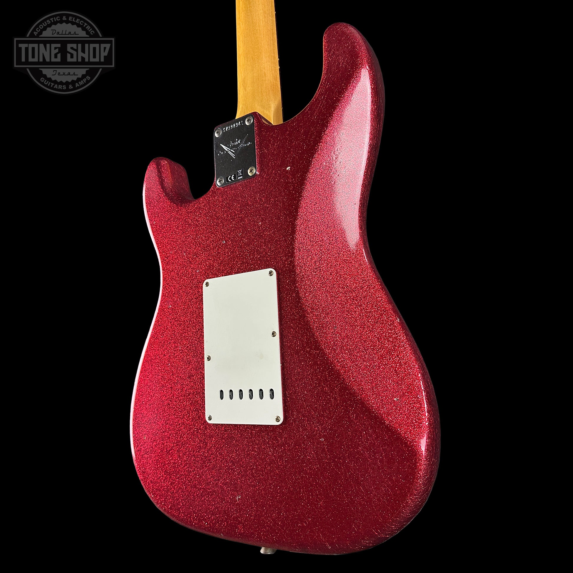 Red glitter electric guitar body on a black background