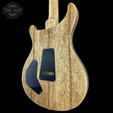 Wooden electric guitar with a black pickguard on a black background, featuring 'Tone Shop' branding.