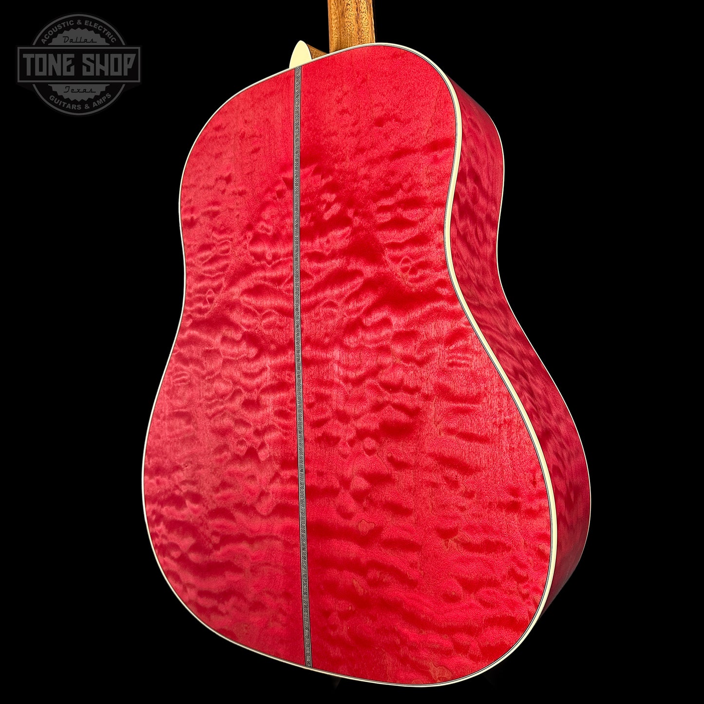 Red acoustic guitar with a textured finish on a black background, featuring 'Tone Shop' logo.