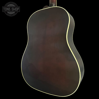 Back view of an acoustic guitar with a dark finish on a black background, featuring the Tone Shop logo.