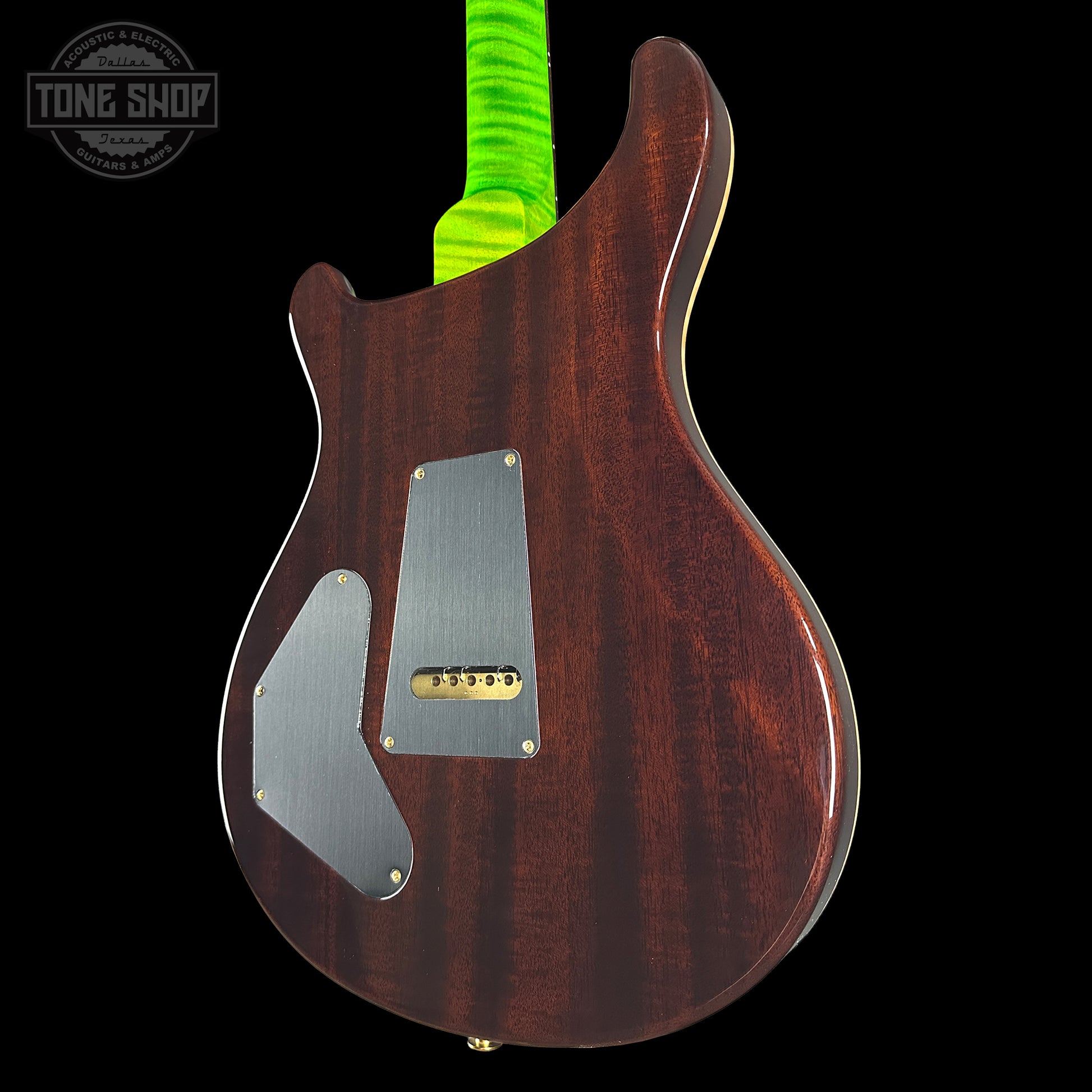 Glossy brown electric guitar body with visible brand logo on a black background