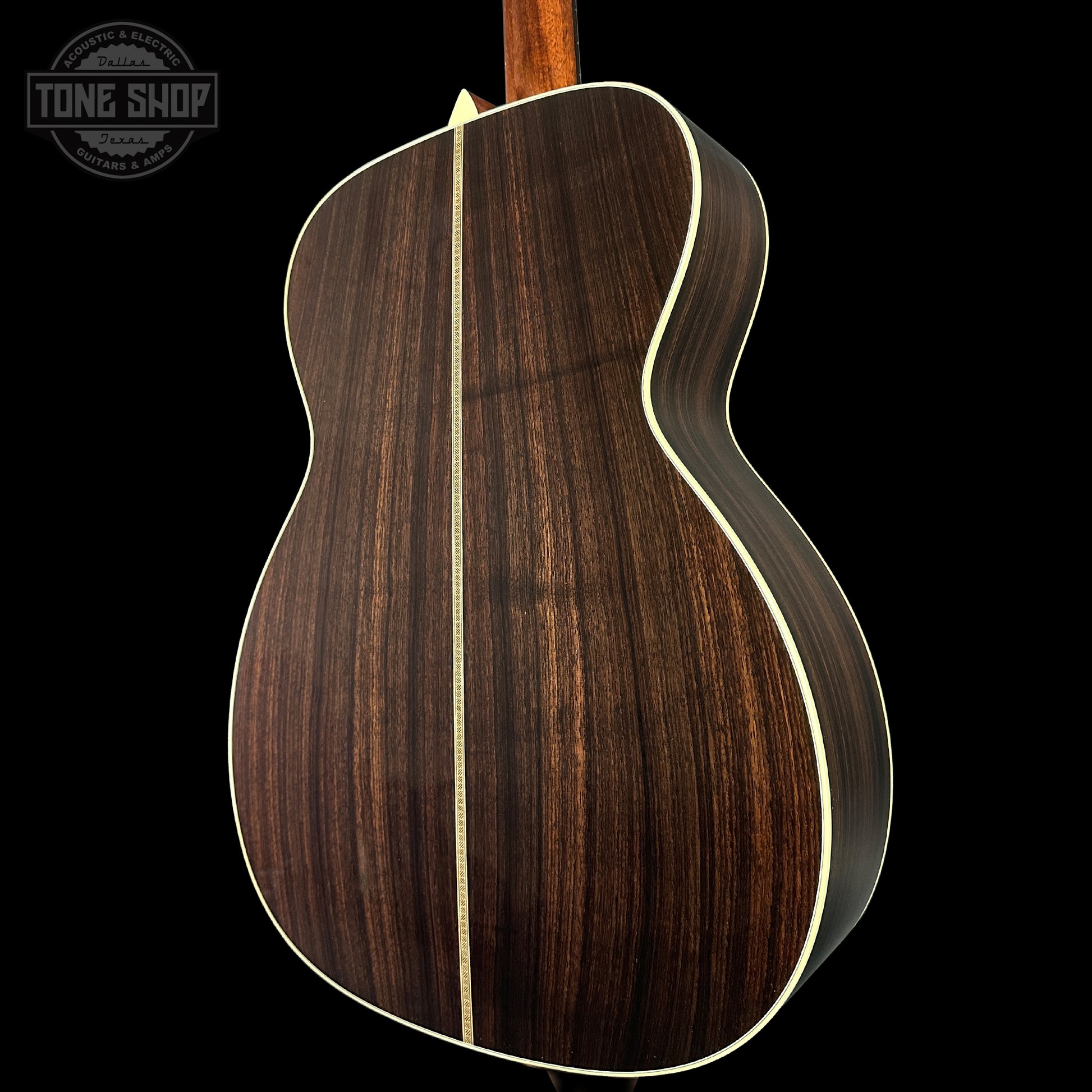 Wooden acoustic guitar body with a visible brand logo in the corner.