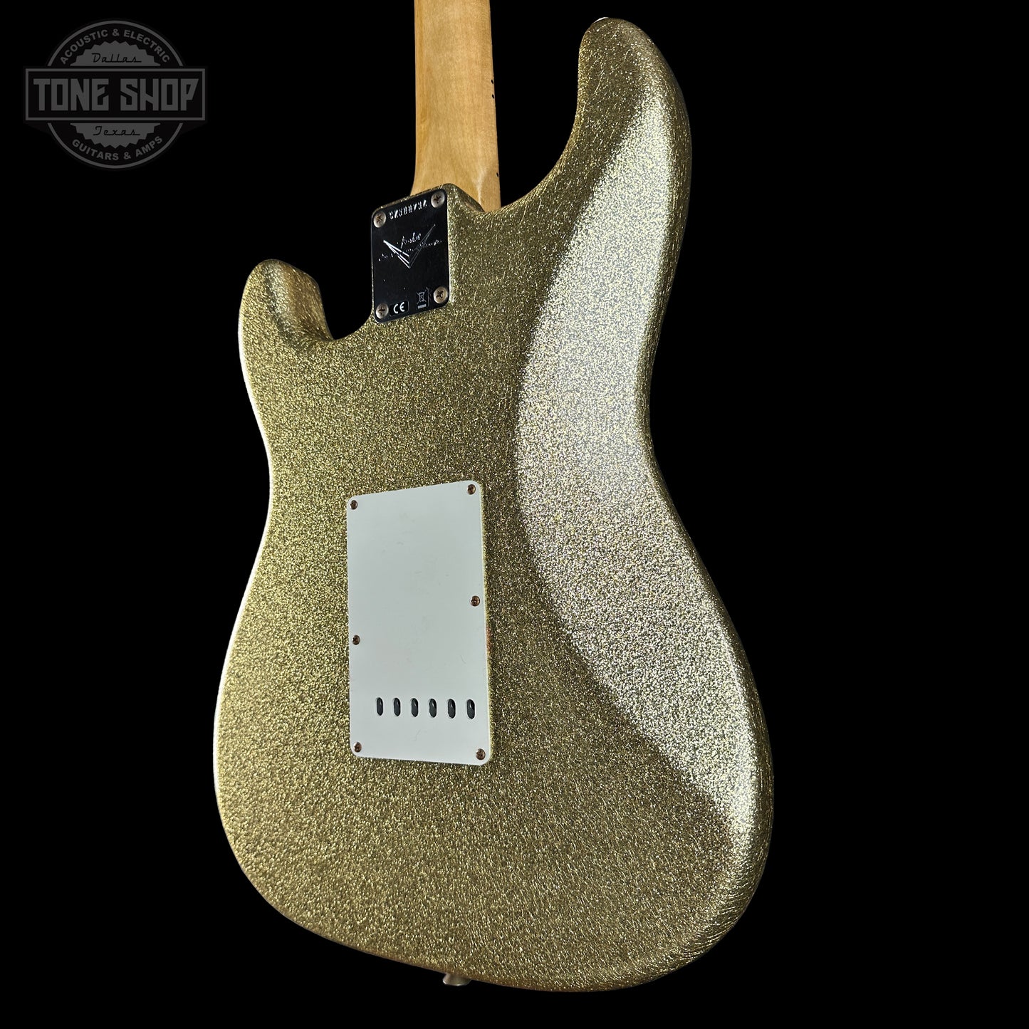 Gold glittery electric guitar body on a black background with 'Tone Shop' logo.