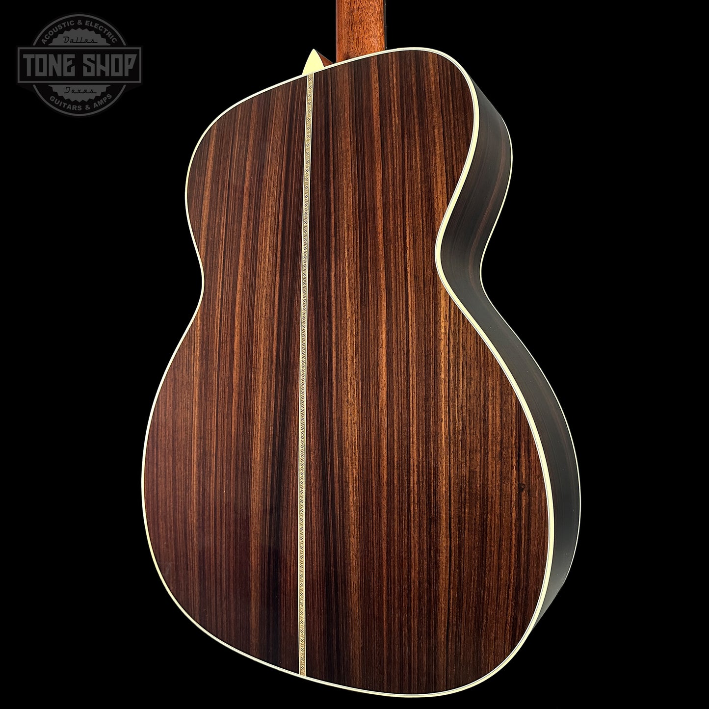 Back view of a wooden acoustic guitar with a visible brand logo in the corner.