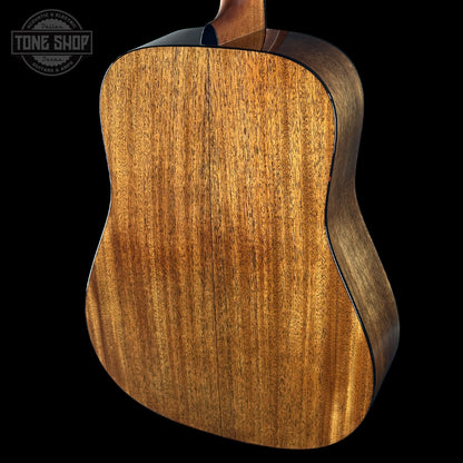Close-up of a wooden acoustic guitar body with 'Tone Shop' logo in the corner.