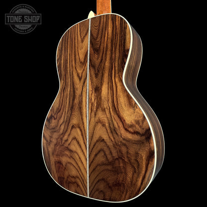Wooden acoustic guitar back with 'Tone Shop' logo in the corner