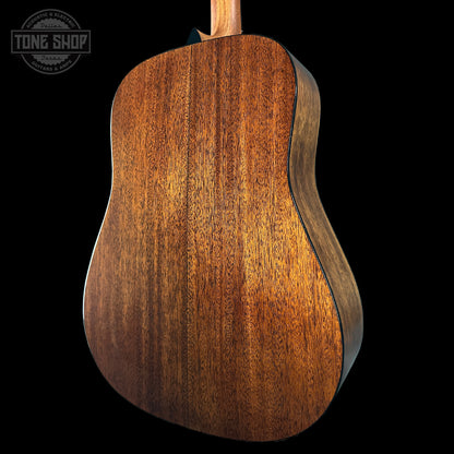 Close-up of a wooden acoustic guitar body with 'Tone Shop' logo.