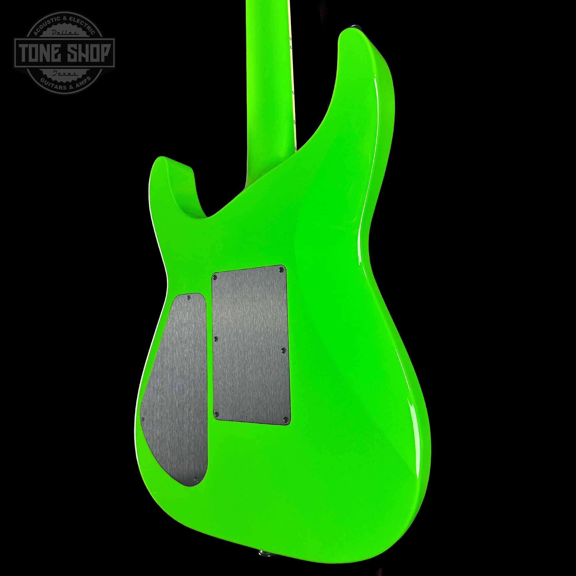 Green electric guitar body with 'Tone Shop' logo in the corner.