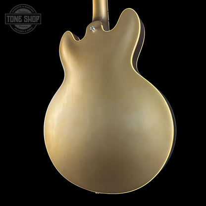 Gold electric guitar body on a black background with 'Tone Shop' logo.