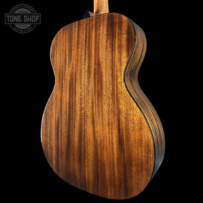 Close-up of a wooden acoustic guitar body with 'Tone Shop' logo.