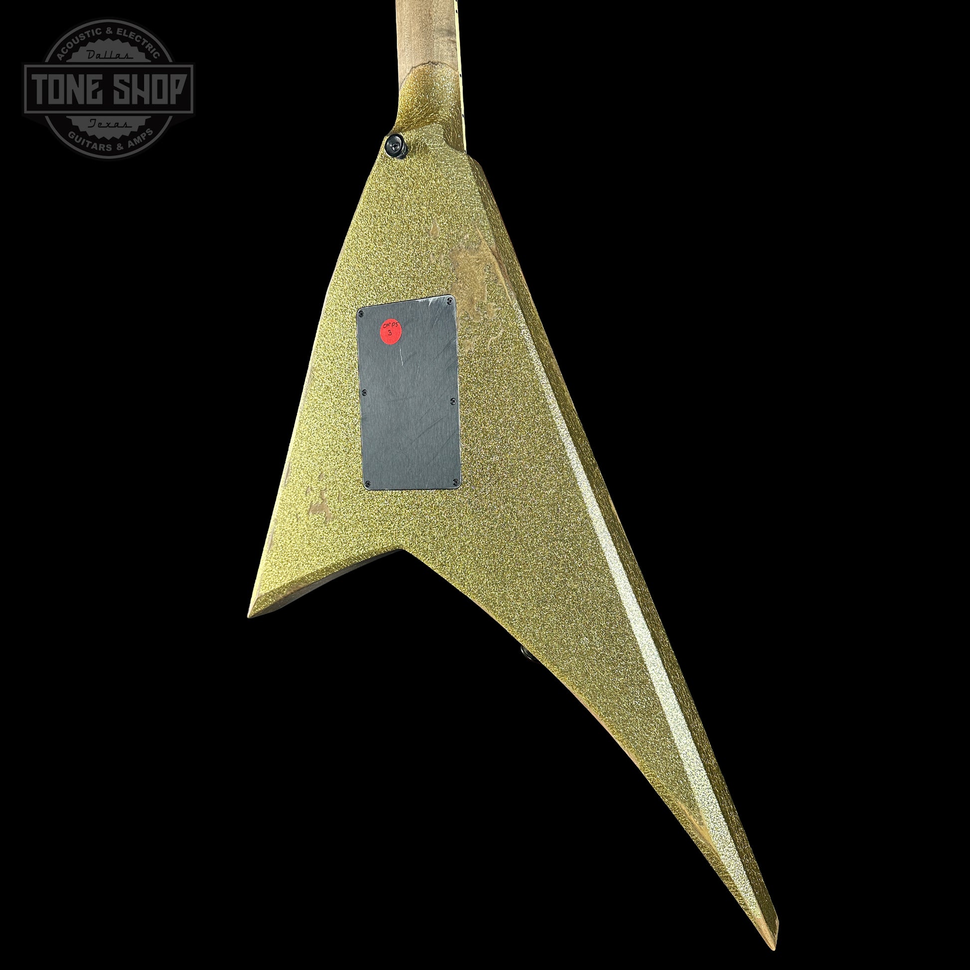 Green electric guitar body with a visible brand logo on a black background