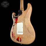 Wooden guitar body with abstract designs on a black background, featuring 'Tone Shop' branding.