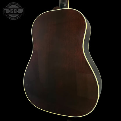 Back view of a dark brown acoustic guitar on a black background with 'Tone Shop' logo.