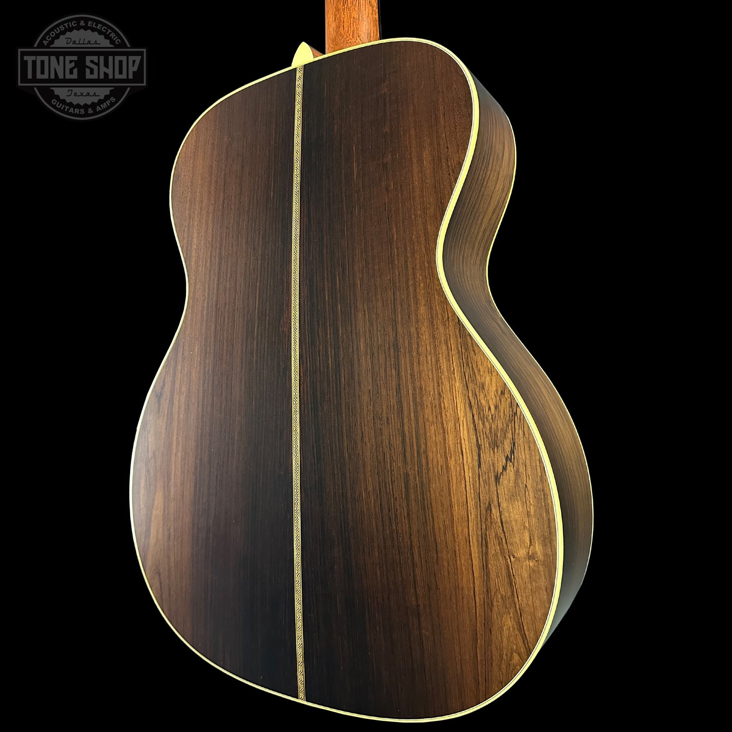 Wooden acoustic guitar body with a visible brand logo in the corner.