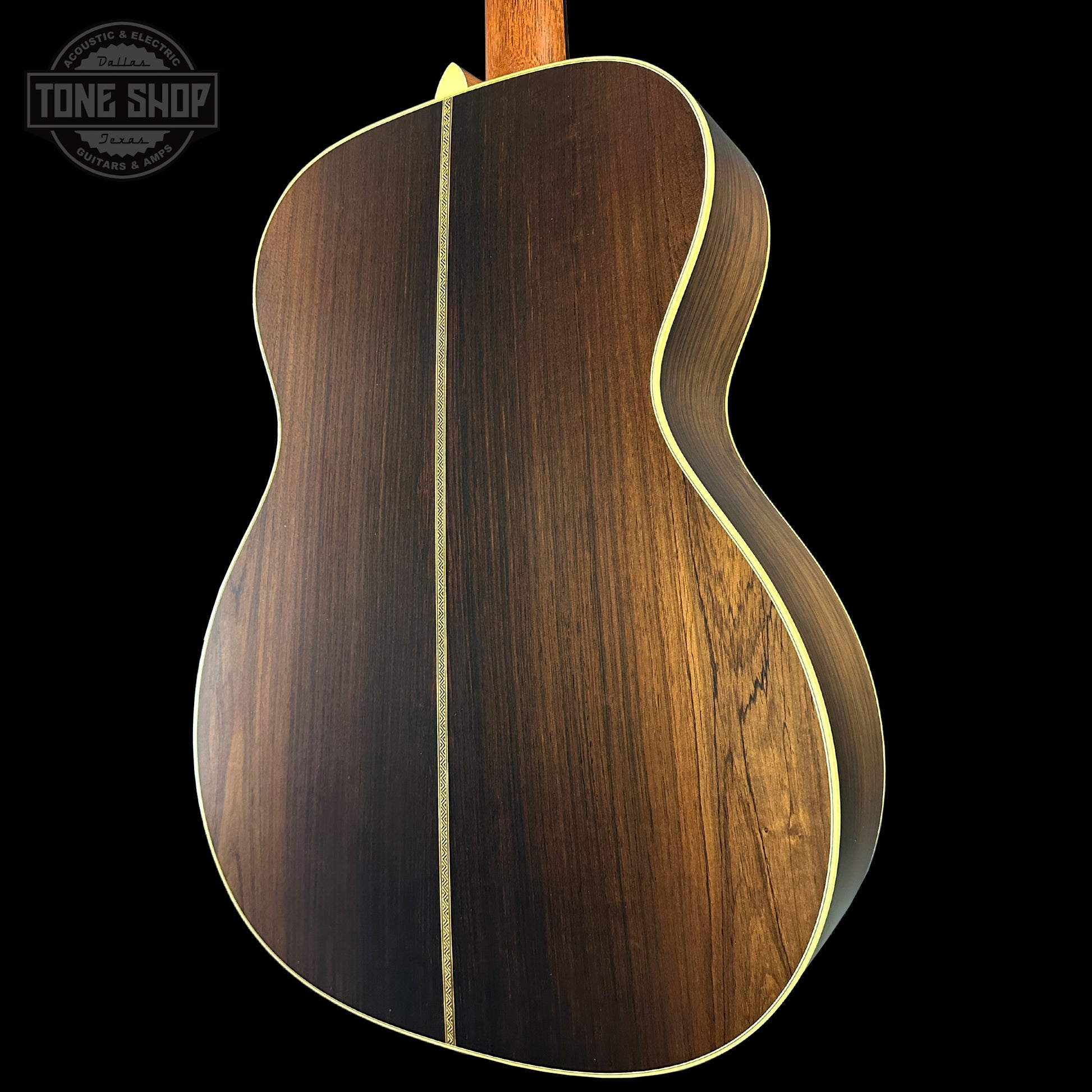 Wooden acoustic guitar body with a visible brand logo in the corner.