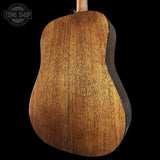 Close-up of a wooden acoustic guitar back with 'Tone Shop' logo.