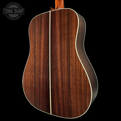 Wooden acoustic guitar back with 'Tone Shop' logo in the corner