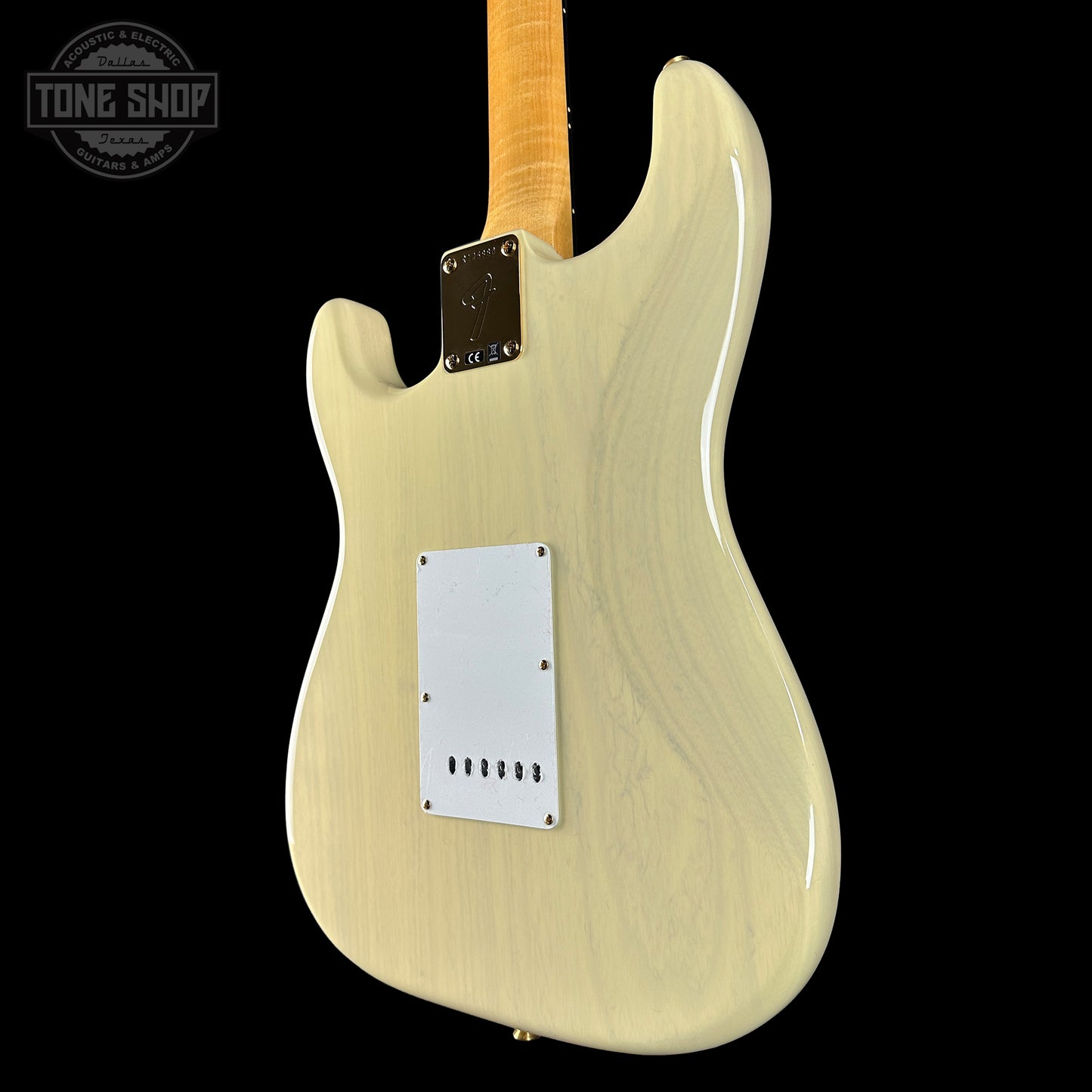Electric guitar body with a blonde finish on a white background, featuring the Tone Shop logo.