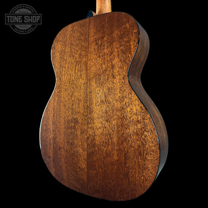 Close-up of a wooden acoustic guitar on a black background with 'Tone Shop' logo.