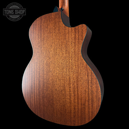 Close-up of a wooden acoustic guitar on a black background with 'Tone Shop' logo.