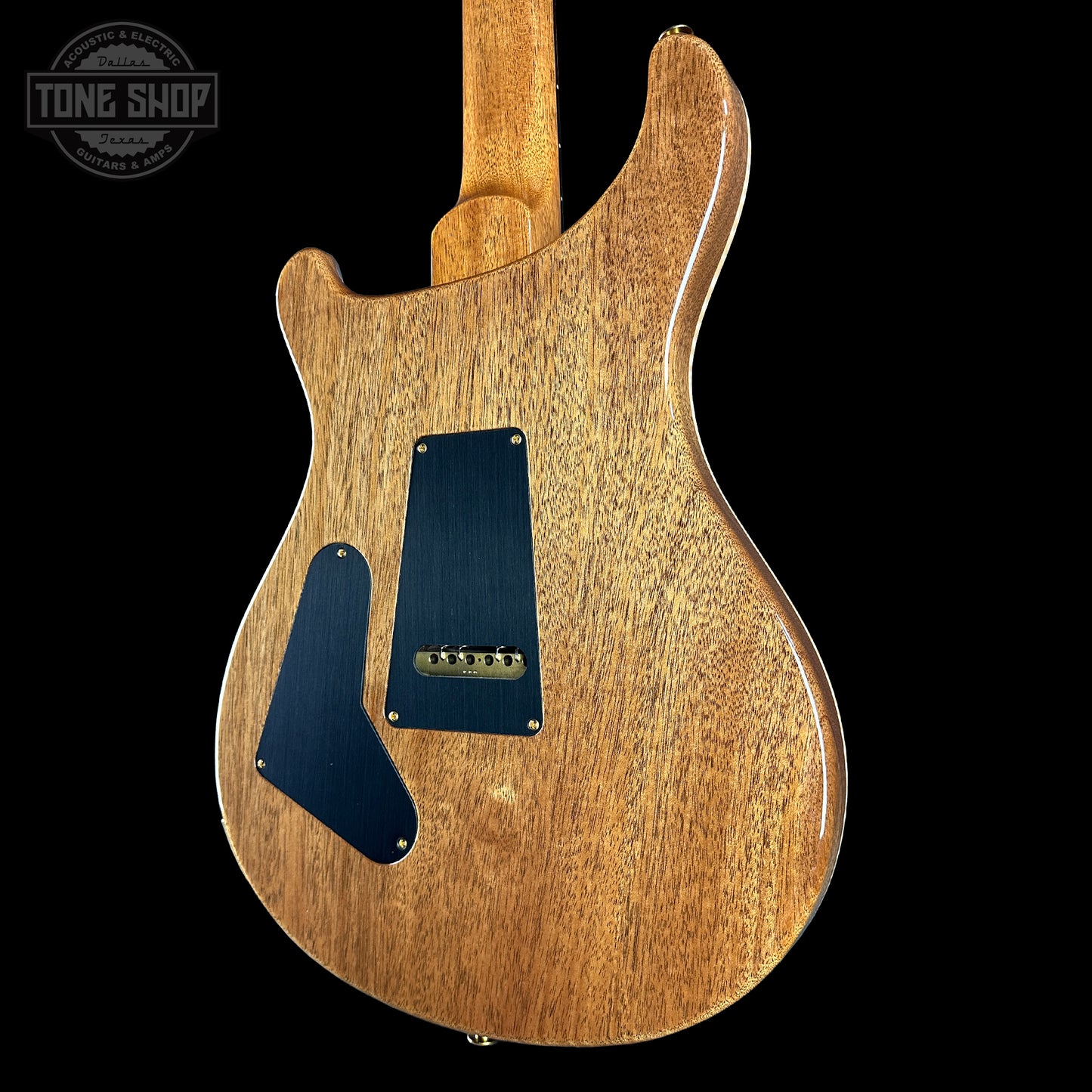 Wooden electric guitar body with a visible brand logo in the corner.