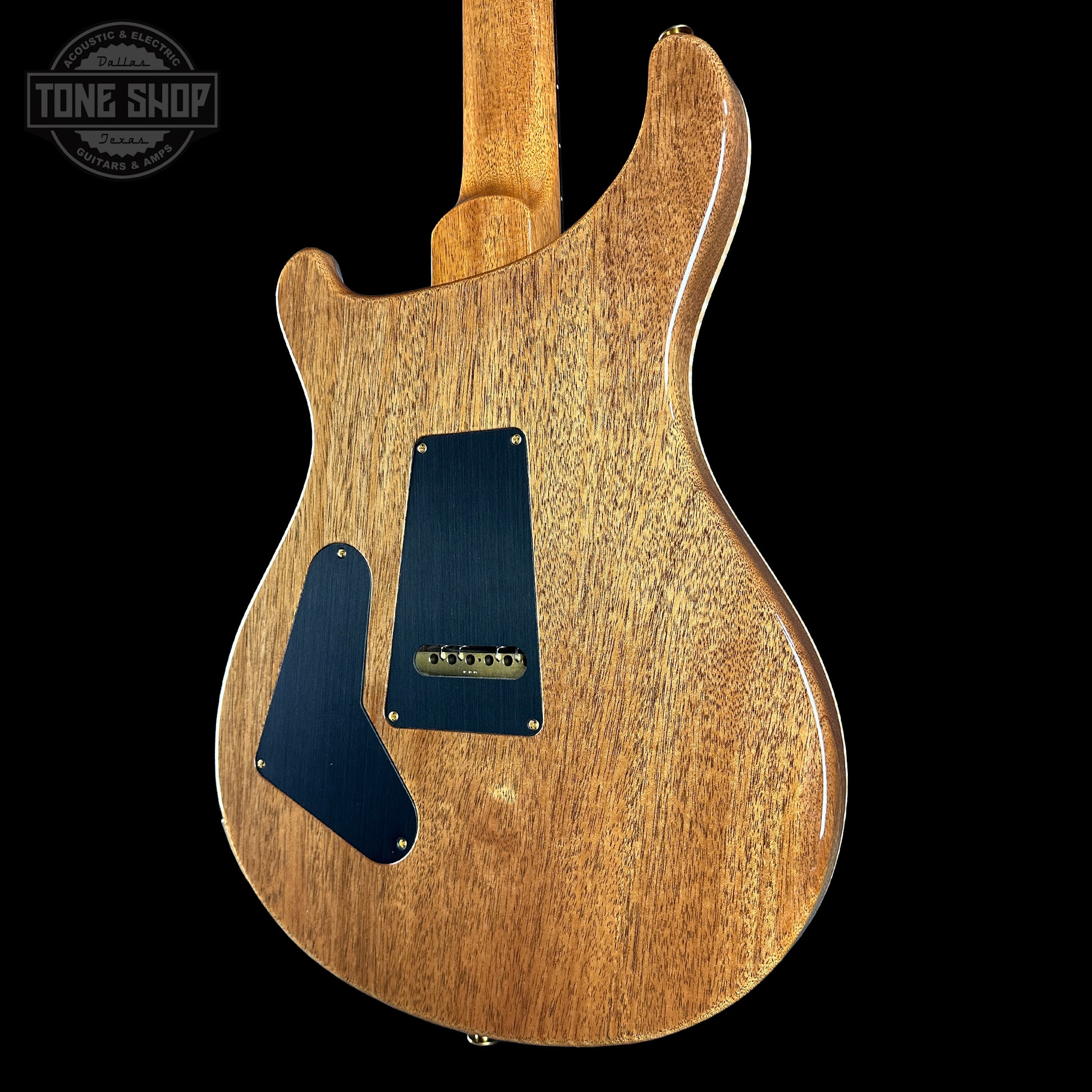 Wooden electric guitar body with a visible brand logo in the corner.