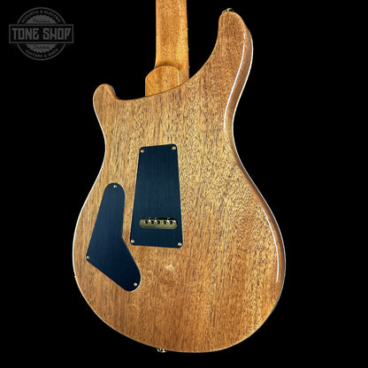 Wooden electric guitar body with a visible brand logo in the corner.