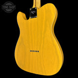 Back of a yellow electric guitar with 'Tone Shop' logo in the corner.