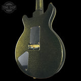 Back view of a black electric guitar with gold glitter finish on a black background, featuring 'Tone Shop' logo.