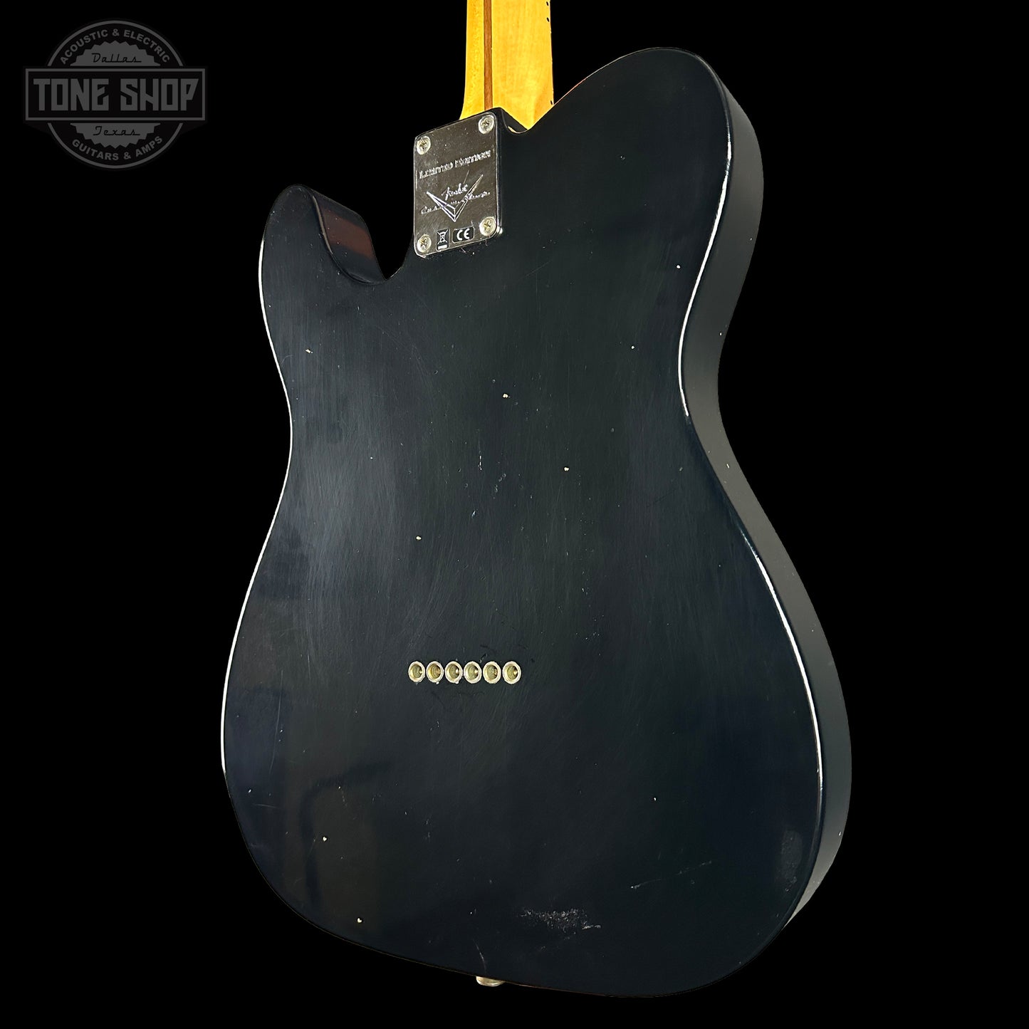 Black electric guitar body with 'Tone Shop' logo in the corner