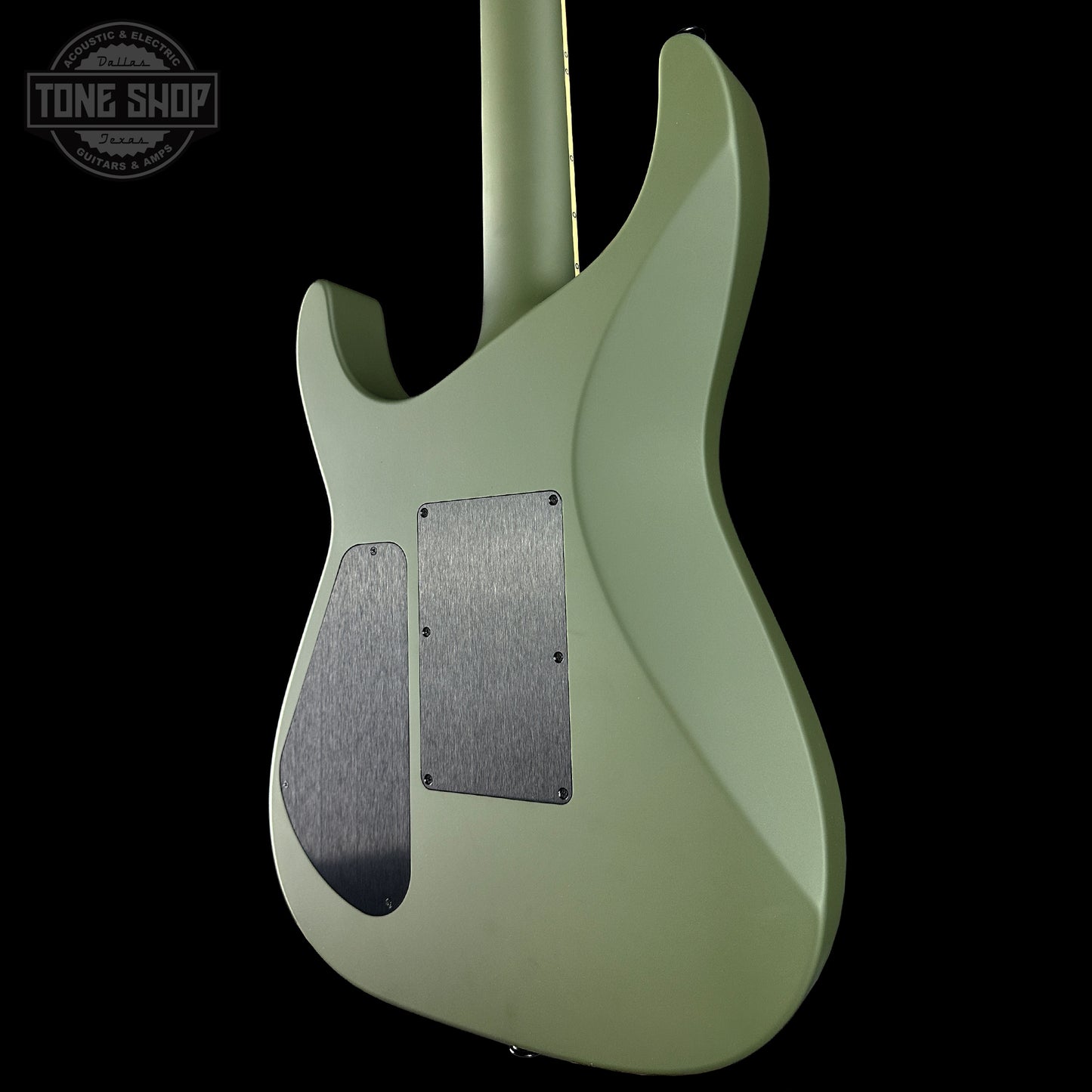 Green electric guitar with a visible brand logo in the corner