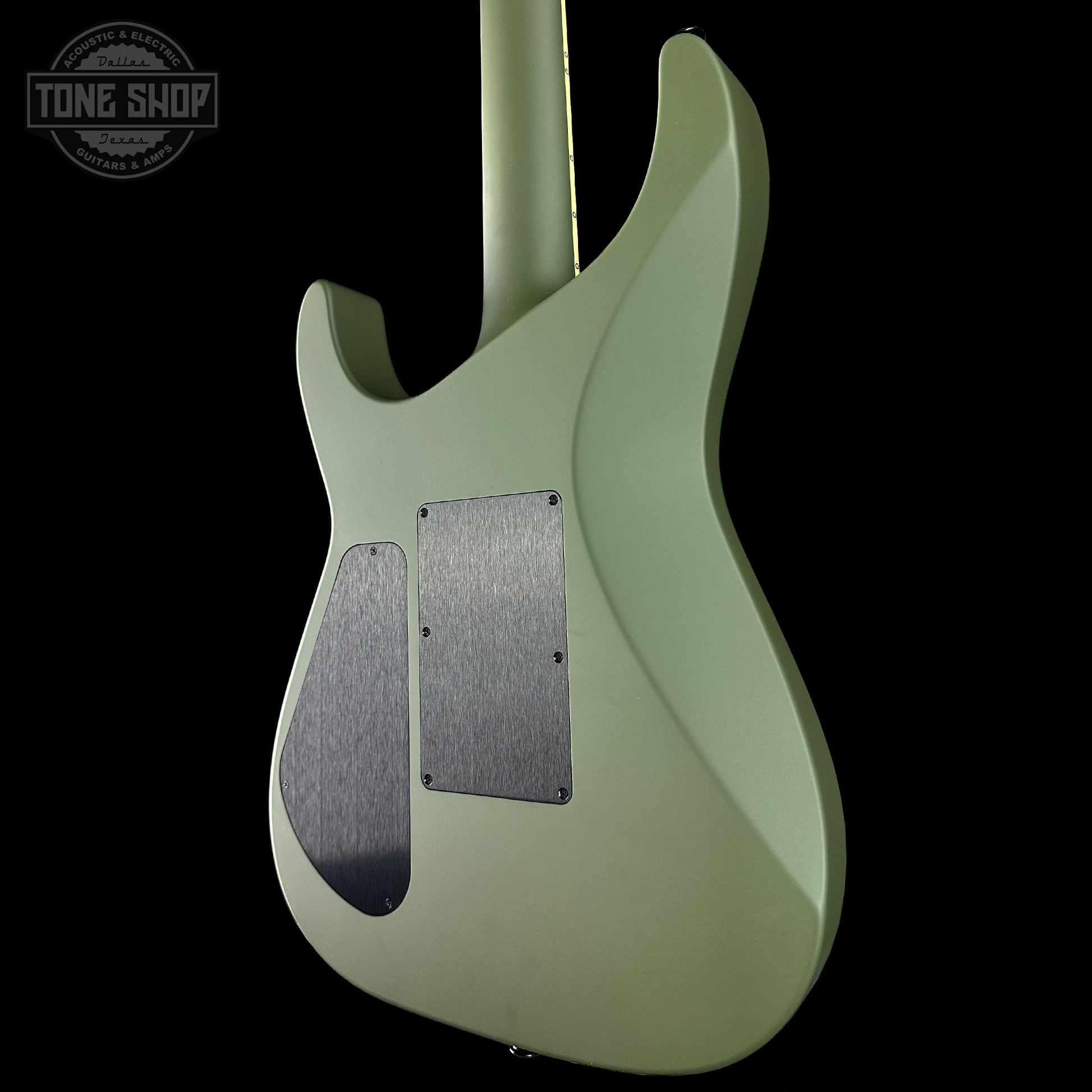Green electric guitar with a visible brand logo in the corner