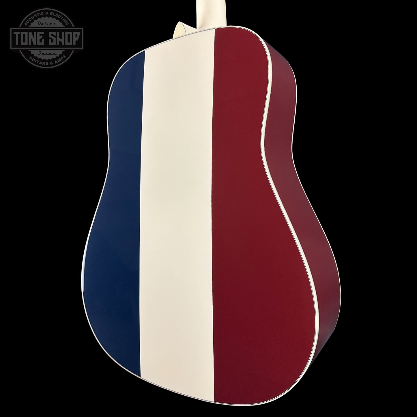 Acoustic guitar with a red, white, and blue striped design on a black background