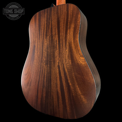 Close-up of a wooden guitar back with 'Tone Shop' logo in the corner.