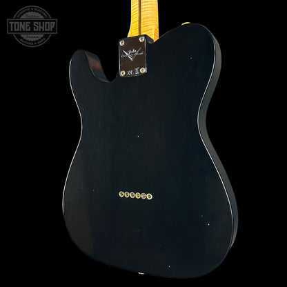 Black electric guitar body with 'Tone Shop' logo in the corner