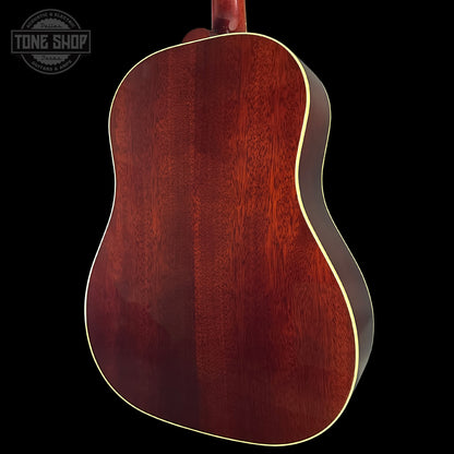 Back view of a wooden acoustic guitar with 'Tone Shop' logo.