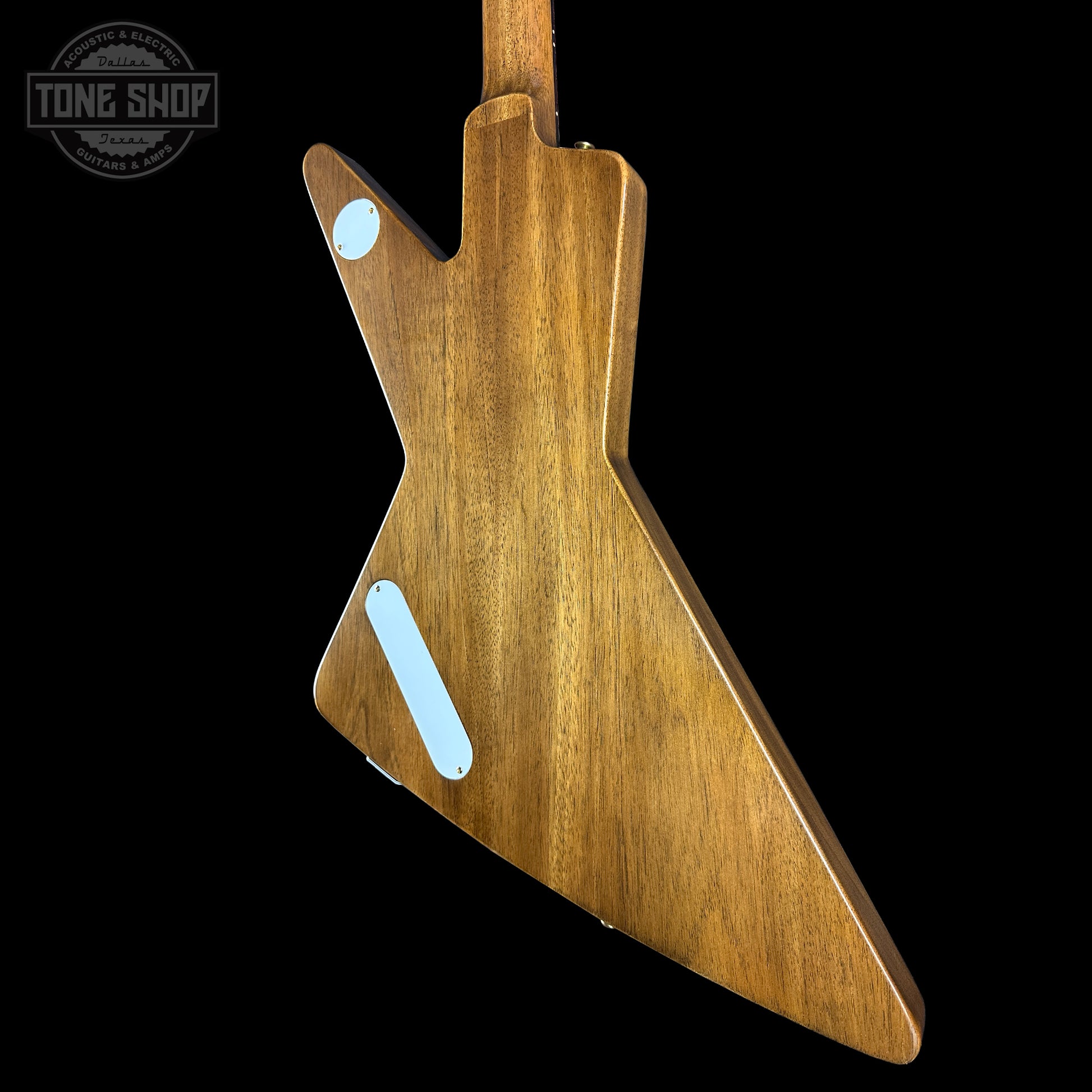 Wooden guitar body with a 'Tone Shop' logo in the corner