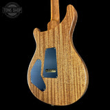 Back view of a wooden electric guitar with a blue pickguard on a black background, featuring 'Tone Shop' branding.