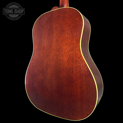 Back view of a wooden acoustic guitar with 'Tone Shop' logo in the corner.