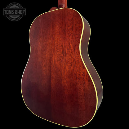 Back view of a wooden acoustic guitar with 'Tone Shop' logo.