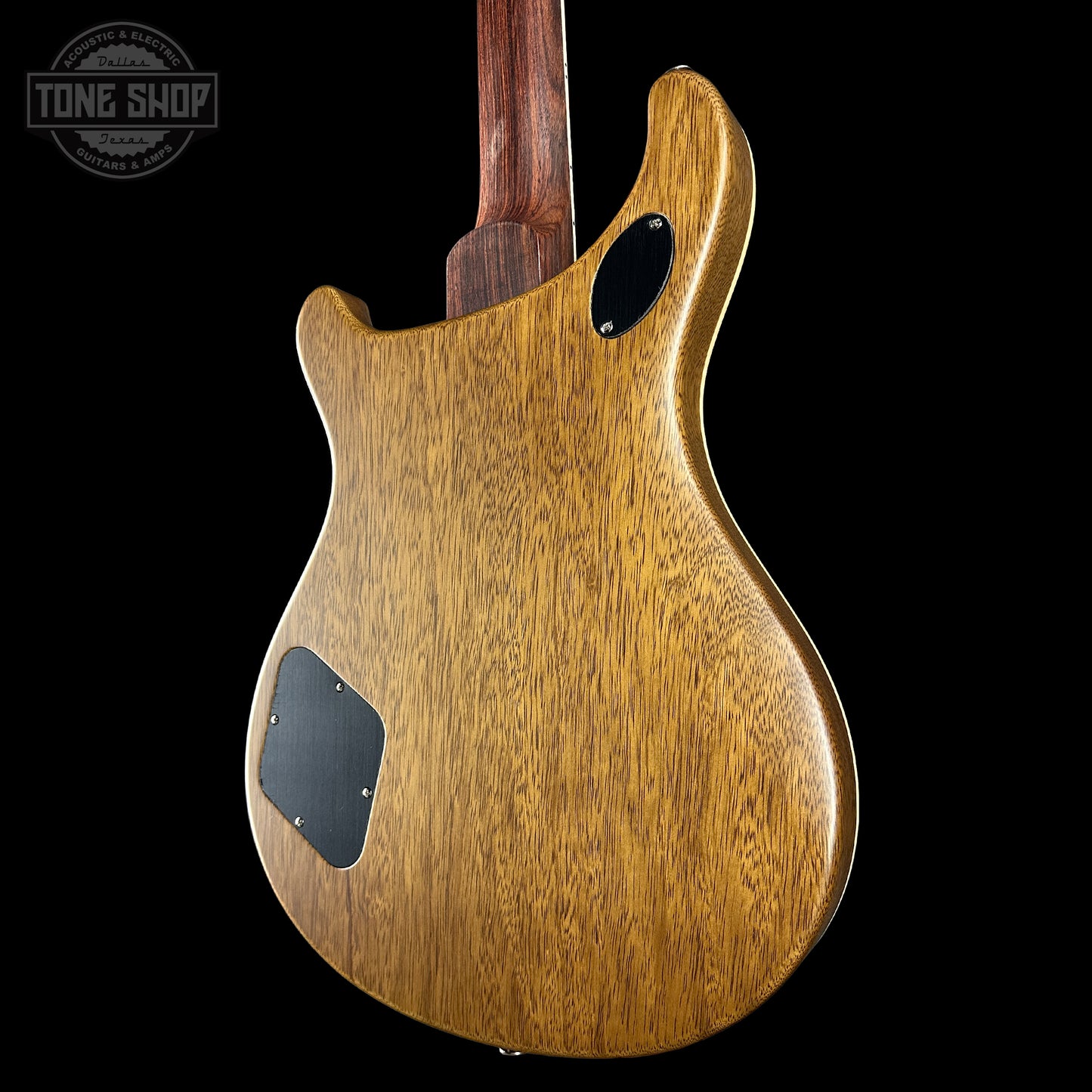 Wooden guitar body with 'Tone Shop' logo in the corner