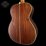 Wooden acoustic guitar back with 'Tone Shop' logo in the corner