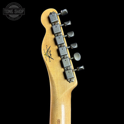 Guitar headstock with tuning pegs on a black background, featuring the Tone Shop logo.