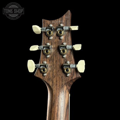 Guitar headstock with tuning pegs on a black background, featuring the Tone Shop logo.