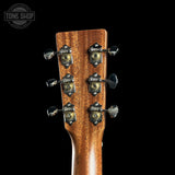 Close-up of a guitar headstock with tuning pegs on a black background, featuring the Tone Shop logo.