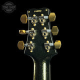 Guitar headstock with tuning pegs on a black background, featuring 'Tone Shop' logo.