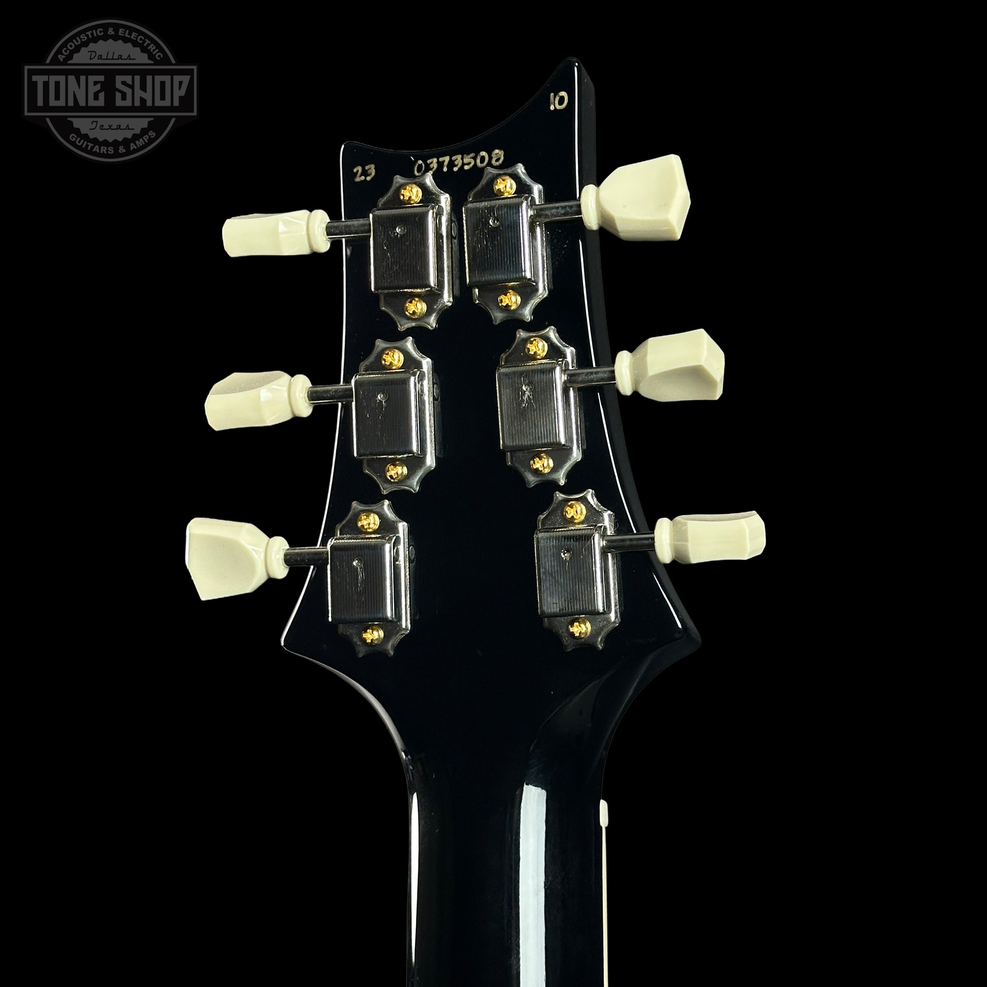 Guitar headstock with tuning pegs on a black background, featuring the Tone Shop logo.
