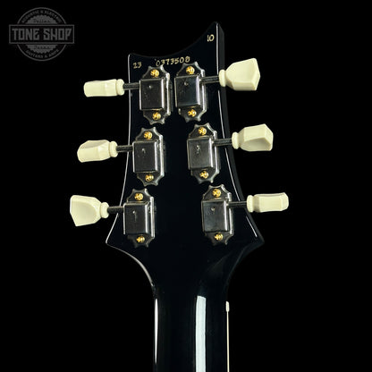 Guitar headstock with tuning pegs on a black background, featuring the Tone Shop logo.